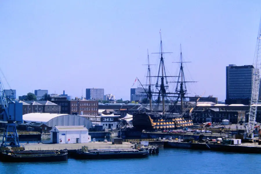 Portsmouth Historic Dockyard seen from the harbour with HMS Victory's masts