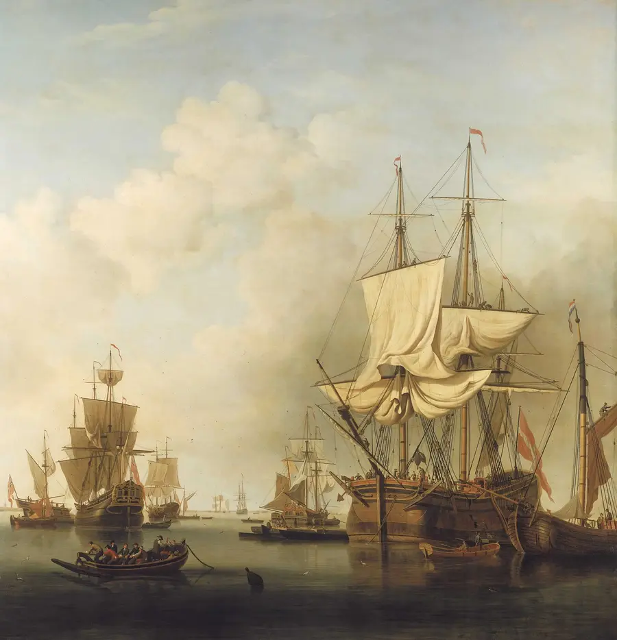 Eighteenth-century painting of a three-masted merchant ship loosing her sails in a calm anchorage with other ships and small boats around her